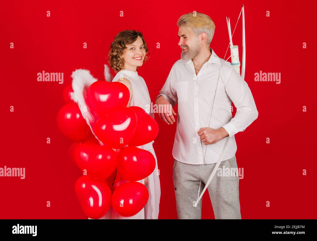 Valentines day couple. Angels with heart shape balloons. Cupid in valentine day. Stock Photo
