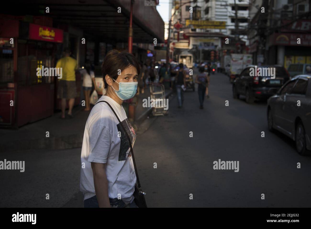 A woman wears a face mask in Manila's Chinatown district as a precaution to the outbreak of the coronavirus. Filipinos remain anxious over a new coronavirus known as Covid-19 which originated in Wuhan, China in December 2019. The Philippines’ Department of Health announced the country’s first death due to the virus on 2 February - the first reported death outside of China. The number of 2019-nCoV cases worldwide has already surpassed that of the 2003 Sars epidemic, with the death toll now over 1300. (Photo by Oliver Haynes / SOPA Images/Sipa USA) Stock Photo