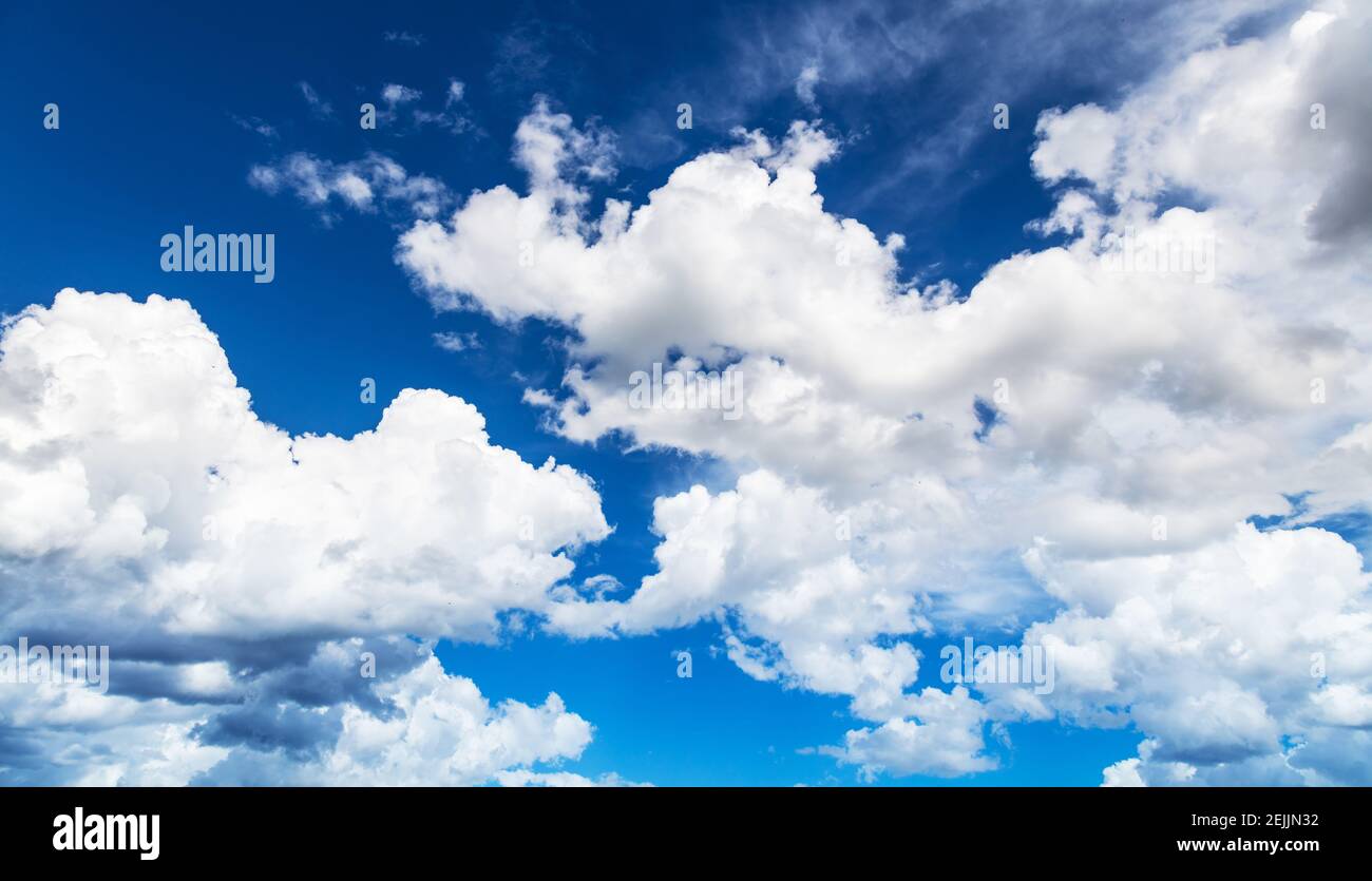 Bright blue sunny sky with fluffy clouds Stock Photo - Alamy