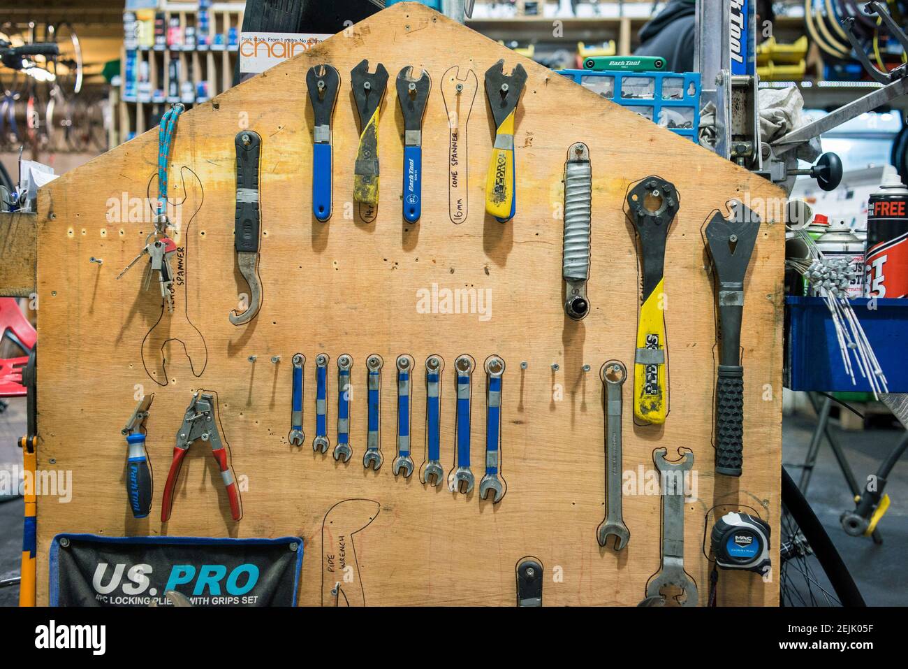 Specialist bike tools all lined up and hanging on a bench in a bike servicing business workshop Stock Photo Alamy