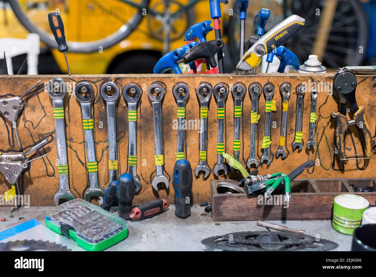 Specialist bike tools all lined up and hanging on a bench in a bike servicing business workshop Stock Photo Alamy