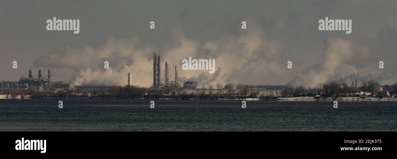 Sarnia, Ontario, Canada - Emissions rise from a string of chemical plants, power plants, and refineries along the St. Clair River on a cold, winter da Stock Photo