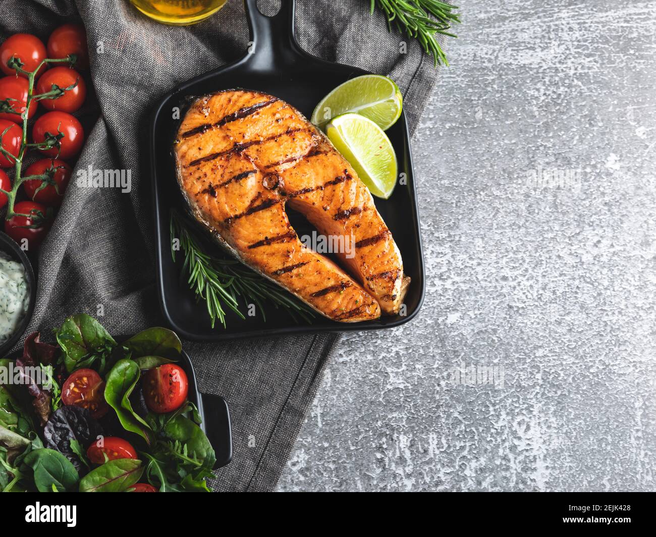 grilled steak fish salmon, trout in a grill pan, spicy, tomato, close up, top view Stock Photo
