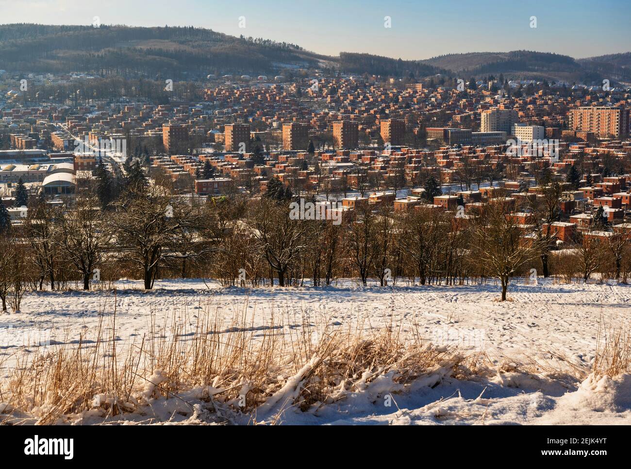 Red brick houses, typical for unique architecture in city Zlin, winter view of residential area with hills. Czech republic. Stock Photo