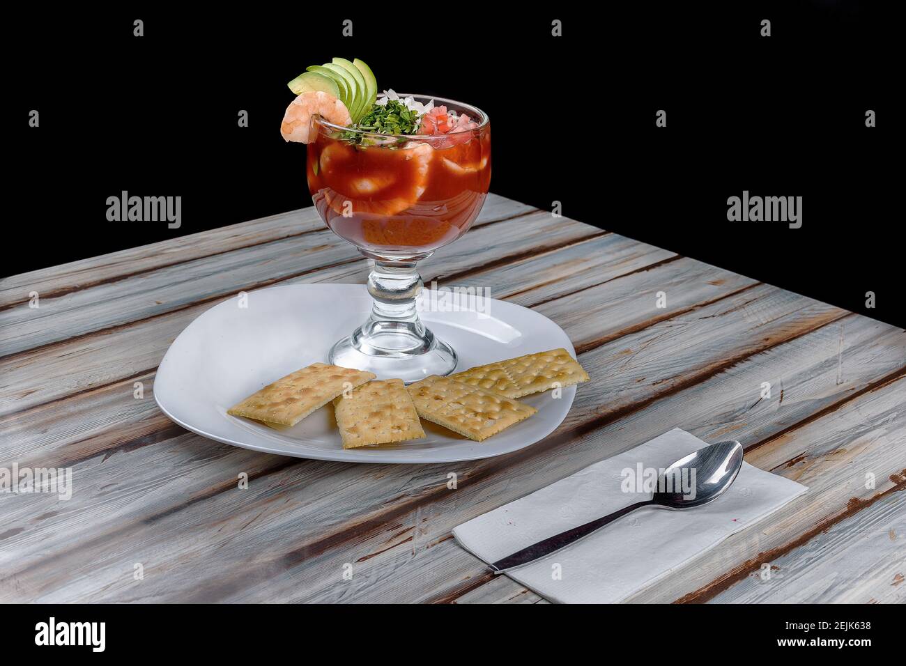 Shrimp cocktail with tomato sauce served in a large glass accompanied by crackers Stock Photo