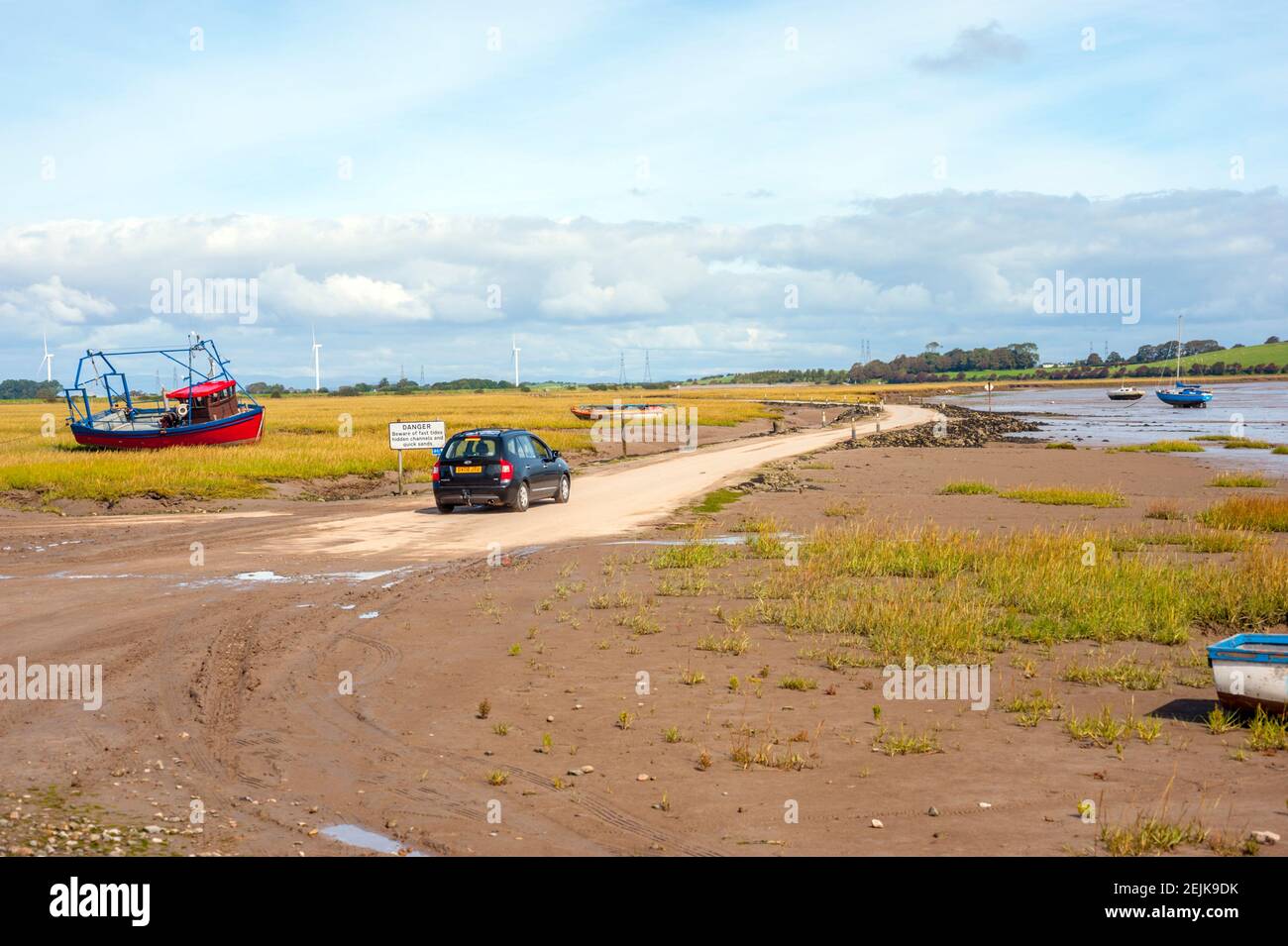 Car at the start of the tidal road linking Sunderland Point and Morecambe, along the banks of the River Lune Stock Photo