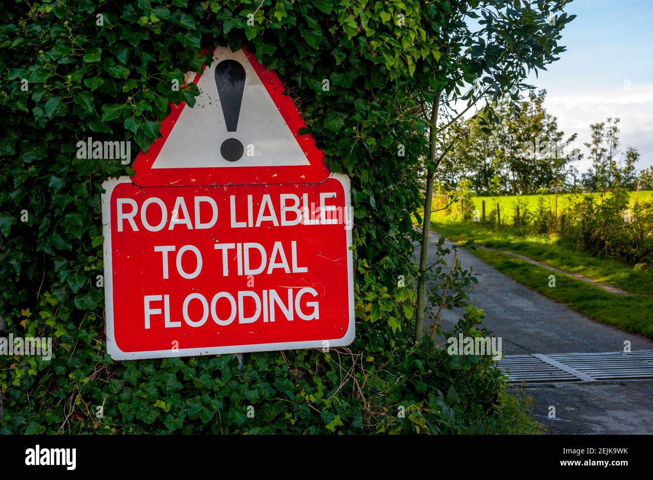 Road liable to flooding sign at start of the tidal road linking Sunderland Point and Morecambe, along the banks of the River Lune Stock Photo