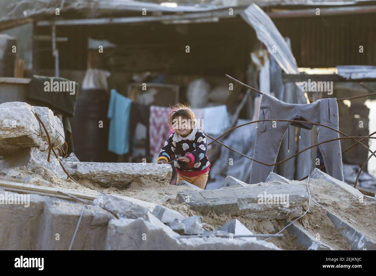 A Palestinian girl plays in the rubble of their house that was ...