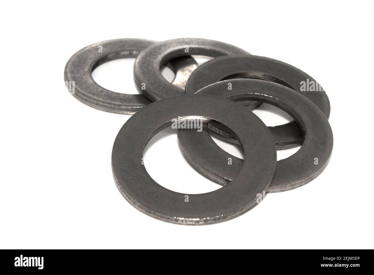 A few big industrial galvanized steel washers on white background Stock
