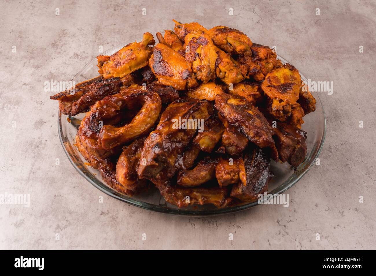 Plate with hot pork ribs prepared on the grill with BBQ sauce Stock Photo