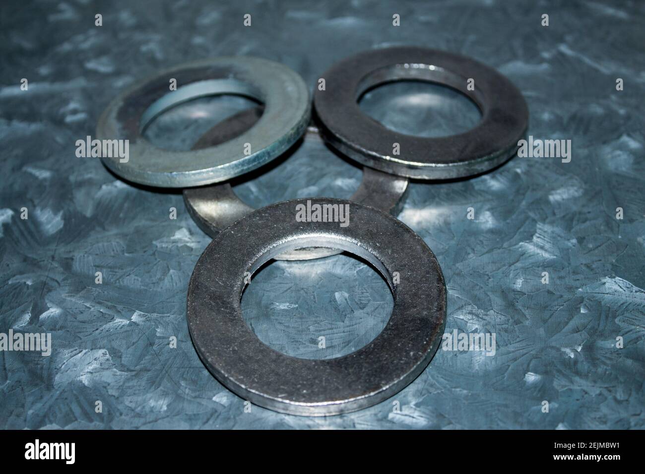 Three big galvanized industrial steel washers Stock Photo