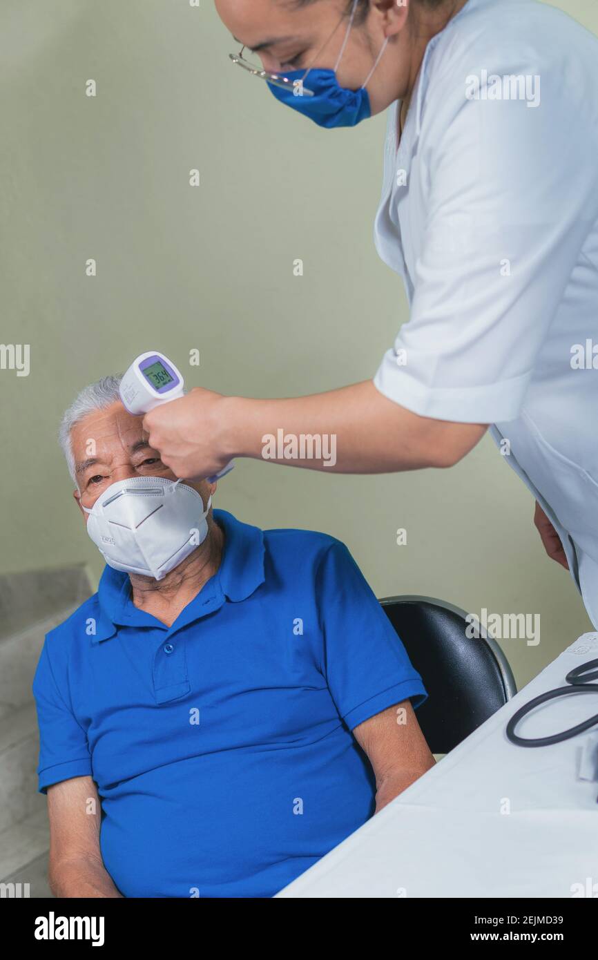 medical check-up of an older man checking his vital signs Stock Photo
