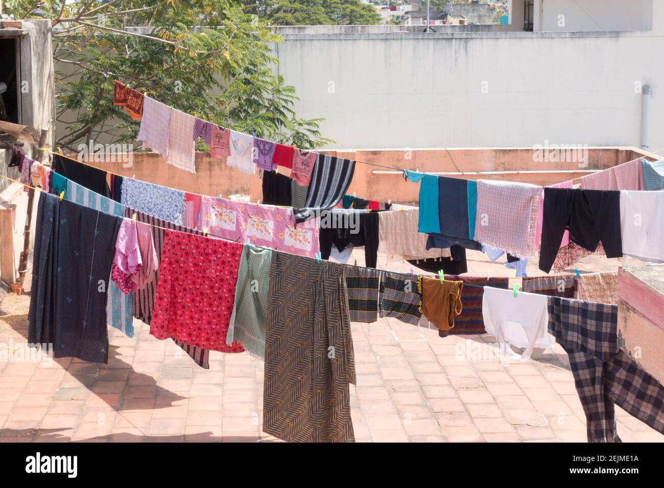 Clothers drying out on the roof on laundry lines in Chennai Stock Photo