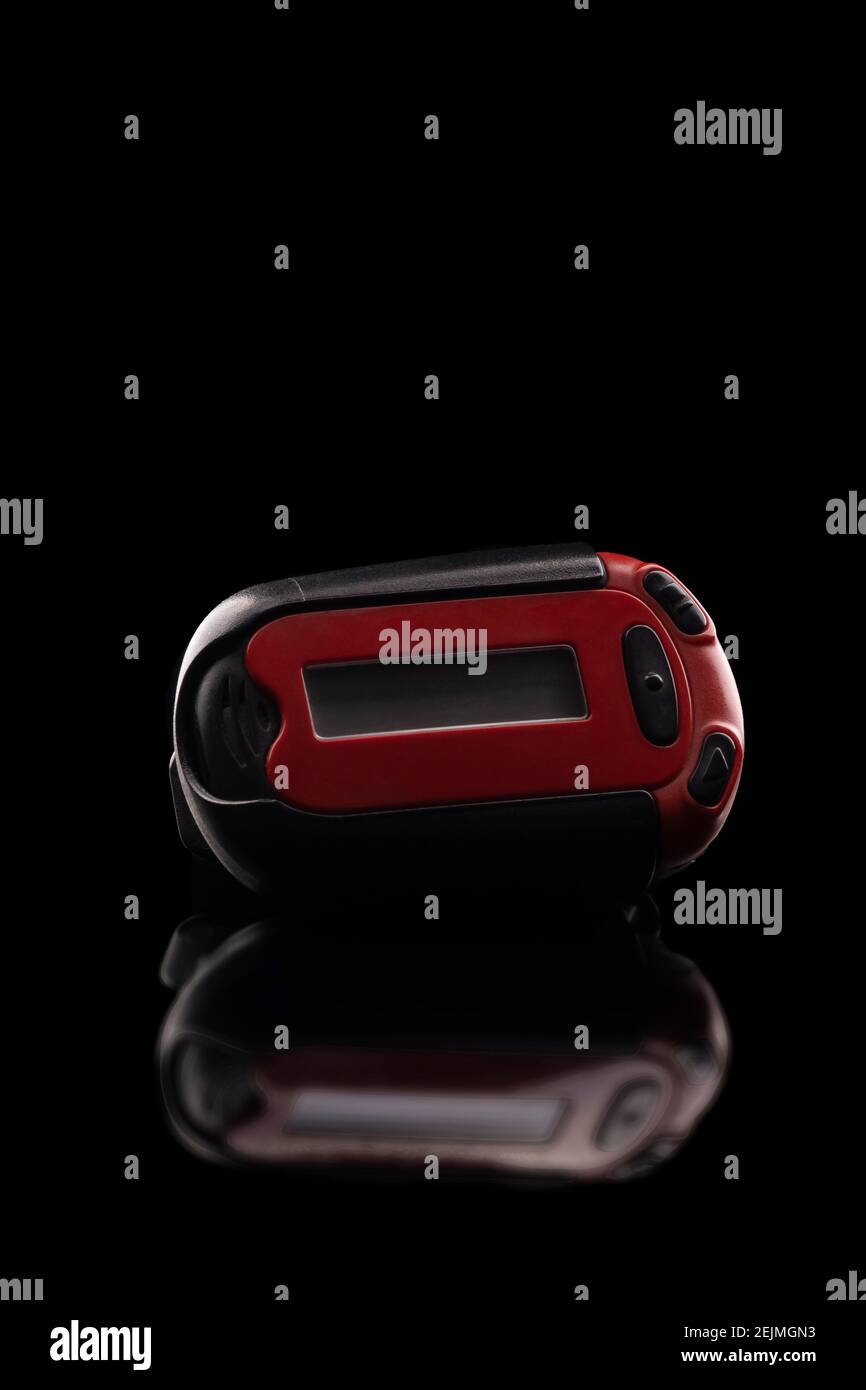 Retro red pager captured isolated on black background and reflective surface Stock Photo