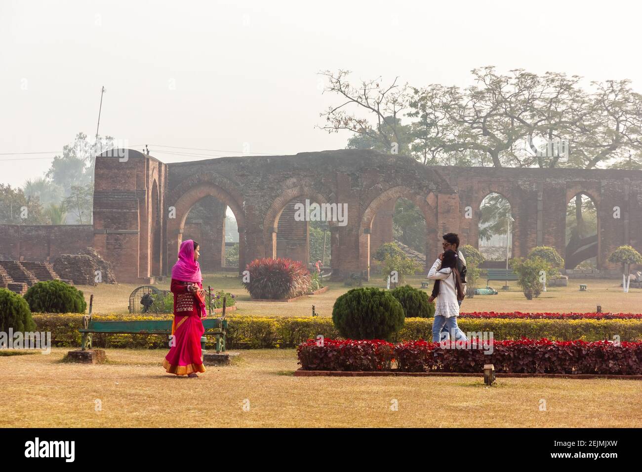 Malda, West Bengal, India - January 2018: Tourists walking in the gardens of the ancient ruins of the Adina Masjid mosque in the village of Pandua. Stock Photo