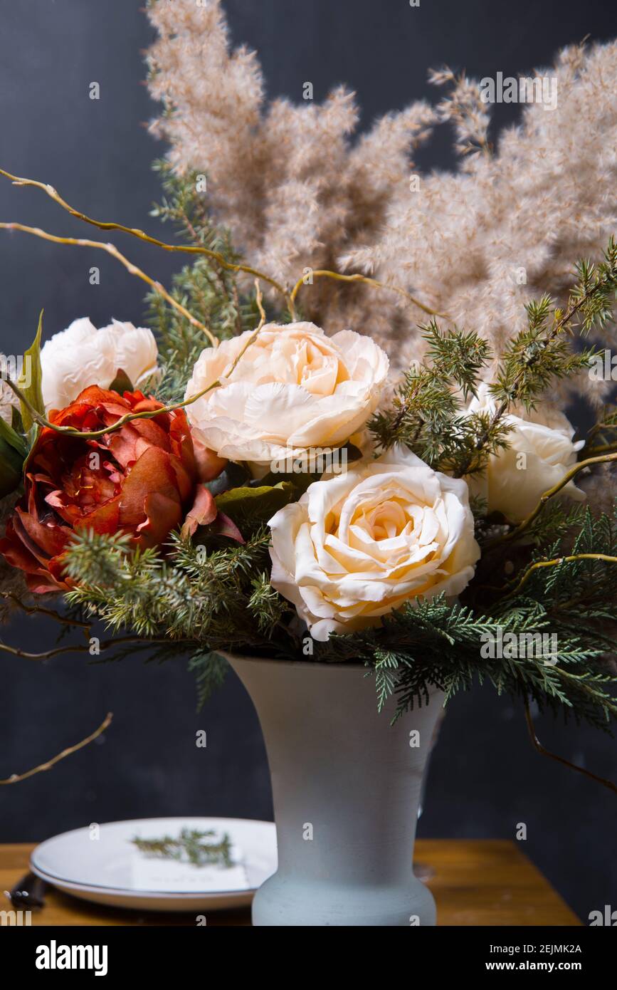 Photo of beautiful floral composition over dark background. Stock Photo