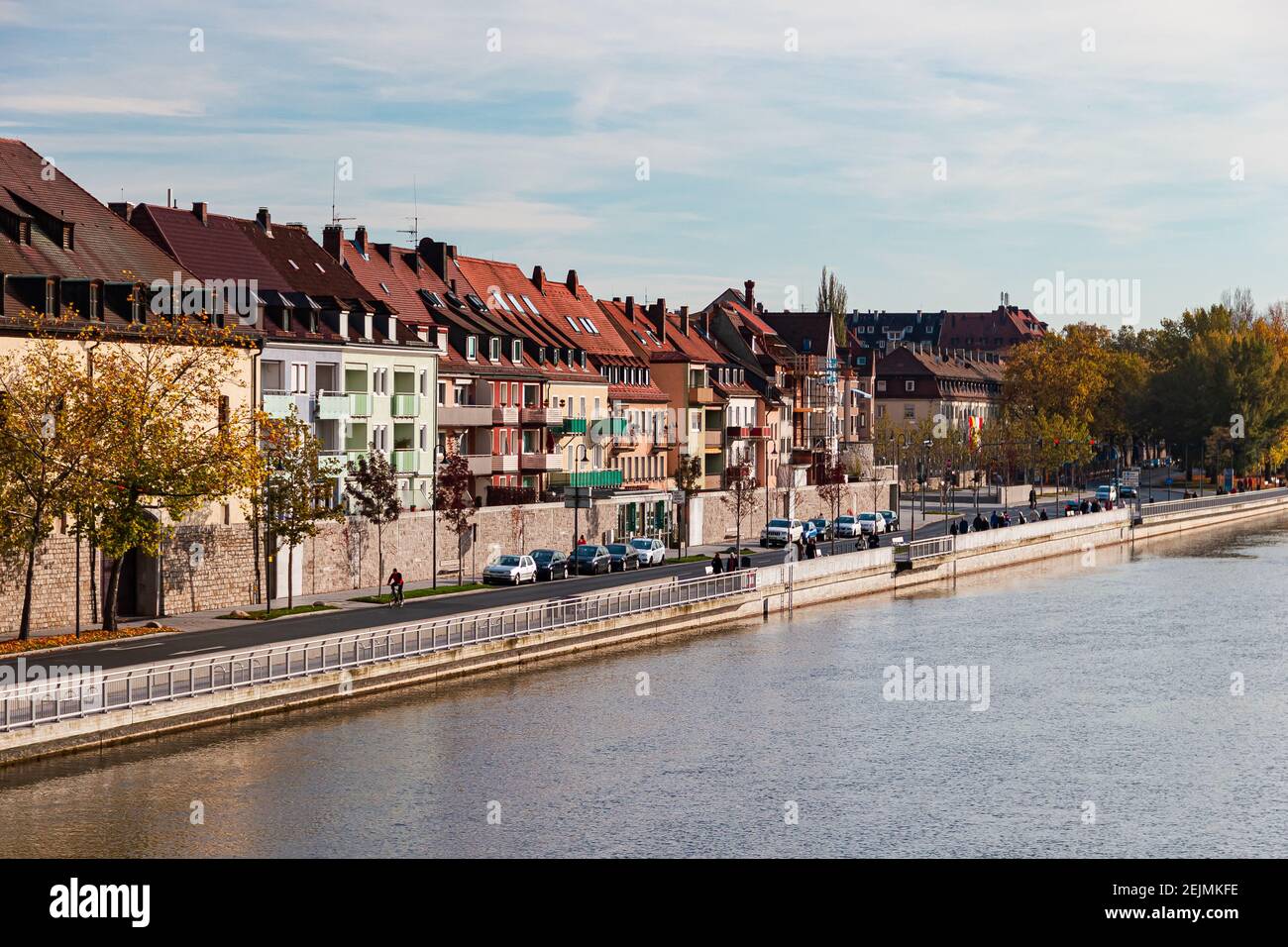 Wuerzburg, Germany, view of Main river, modern typical German houses are standing along, people stroll along the embankment Stock Photo