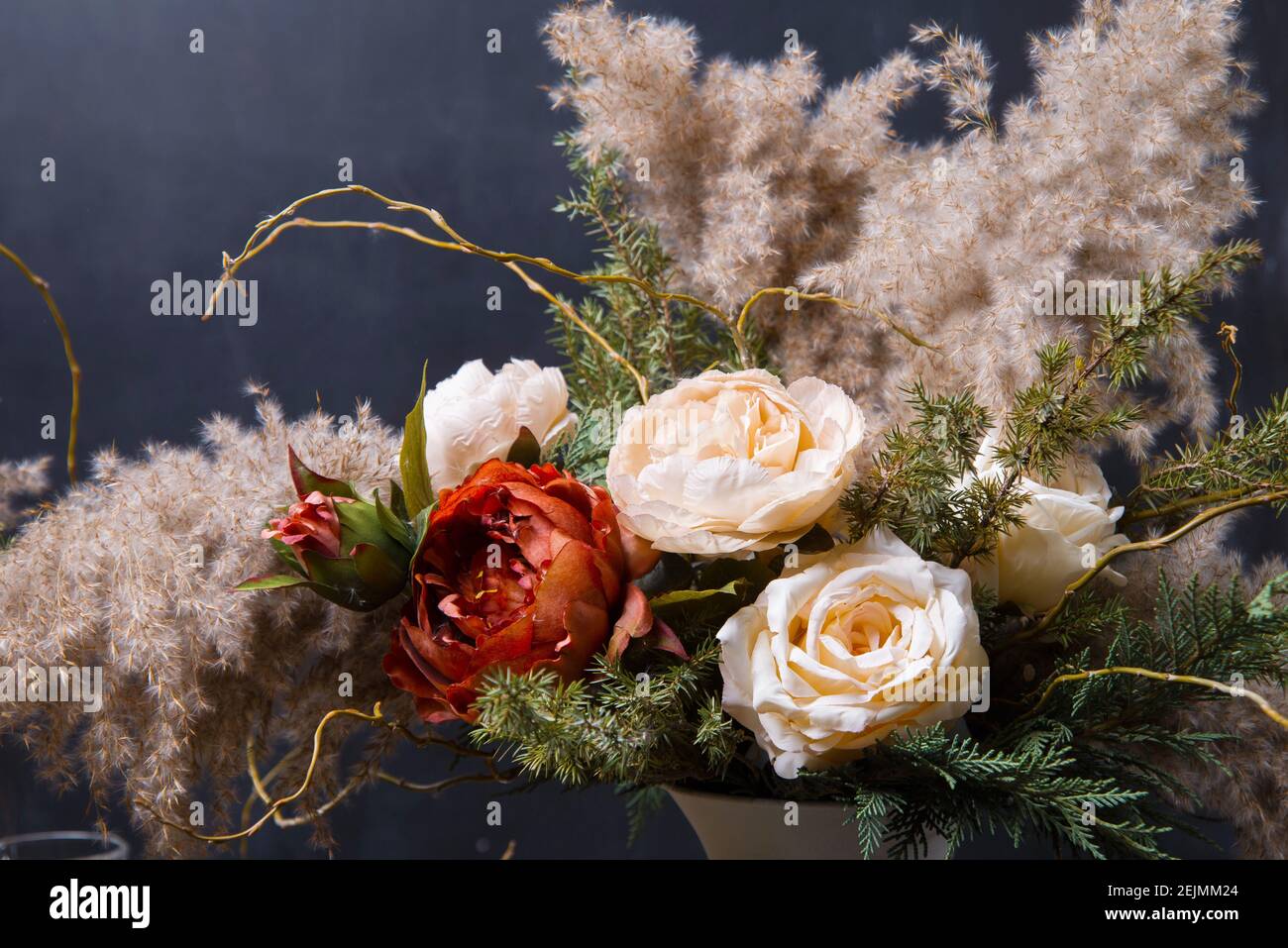 Close up photo of beautiful floral composition over dark background. Stock Photo