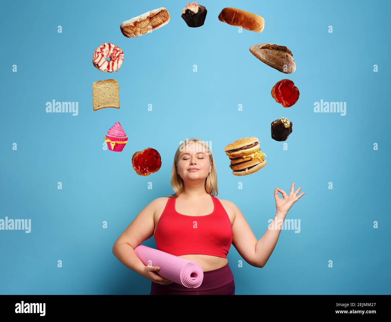 Fat girl does gym at home but she always thinks about to eat. Cyan background Stock Photo