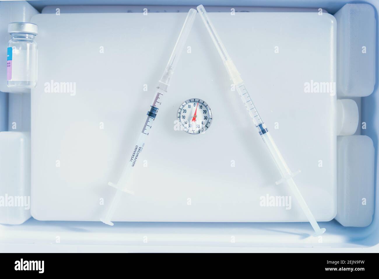 closeup of some empty syringes placed on a cold container Stock Photo