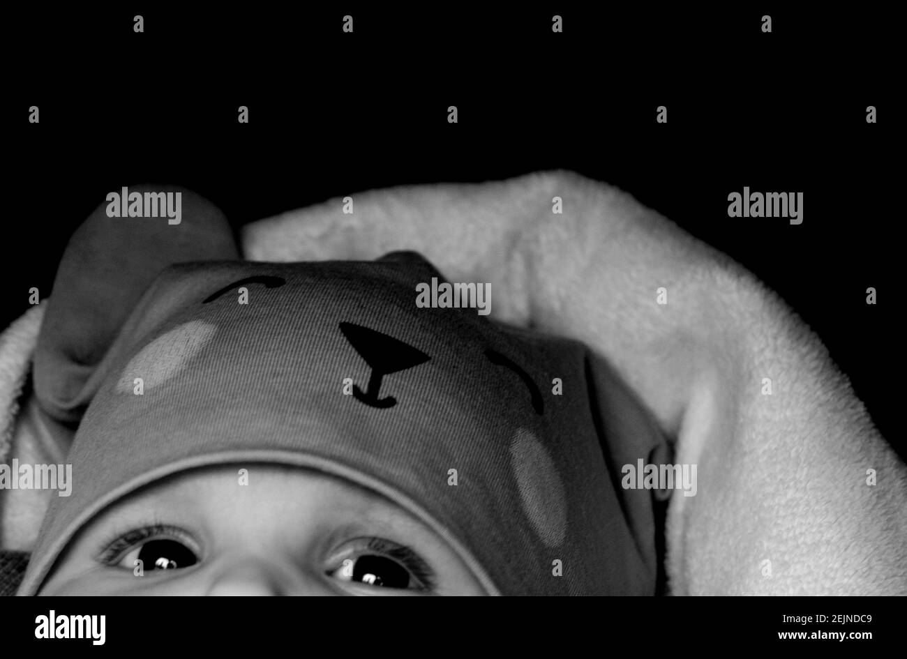 Cute little baby girl looking into the camera Stock Photo - Alamy
