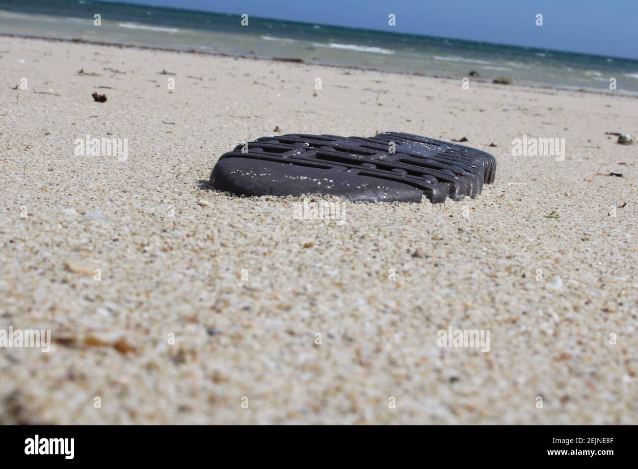 The washed up sole of a boot at Kouderika Beach outside of Port Moresby Stock Photo