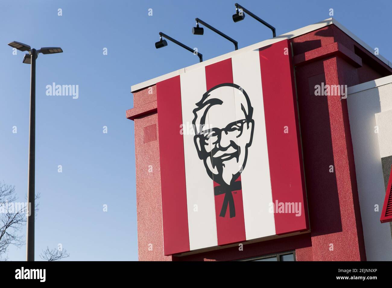 A logo sign outside of a Kentucky Fried Chicken (KFC) fast food ...