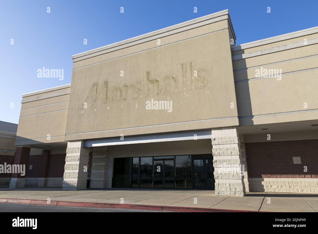 A the faded outline of a Marshalls logo sign outside of a closed retail