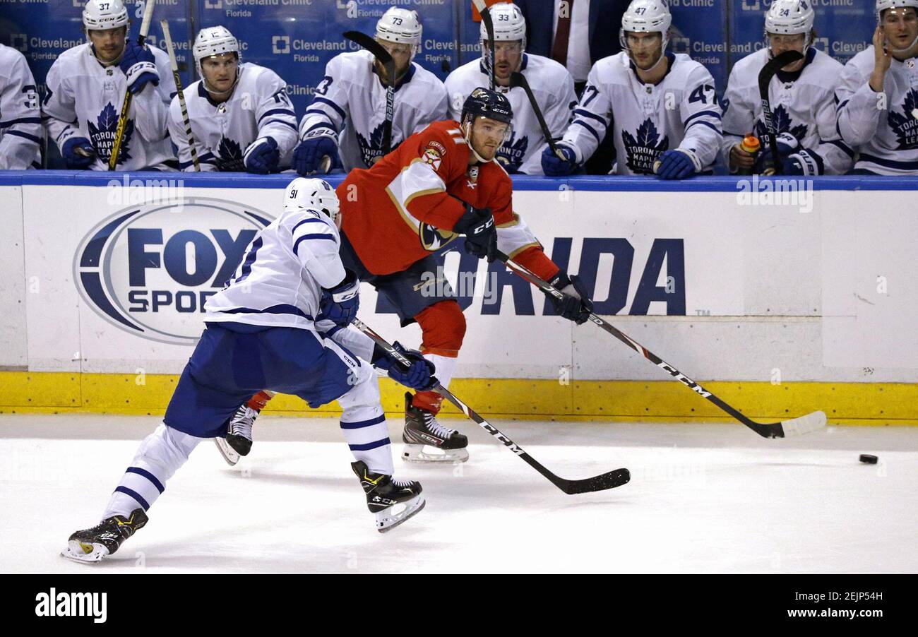The Florida Panthers' Jonathan Huberdeau (11) controls the puck in front of the Toronto Maple Leafs bench as Toronto's John Tavares (91) closes in during the third period at the BB&T Center in Sunrise, Fla., on Thursday, Feb. 27, 2020. The Maple Leafs won, 5-3. (David Santiago/Miami Herald/TNS) Stock Photo