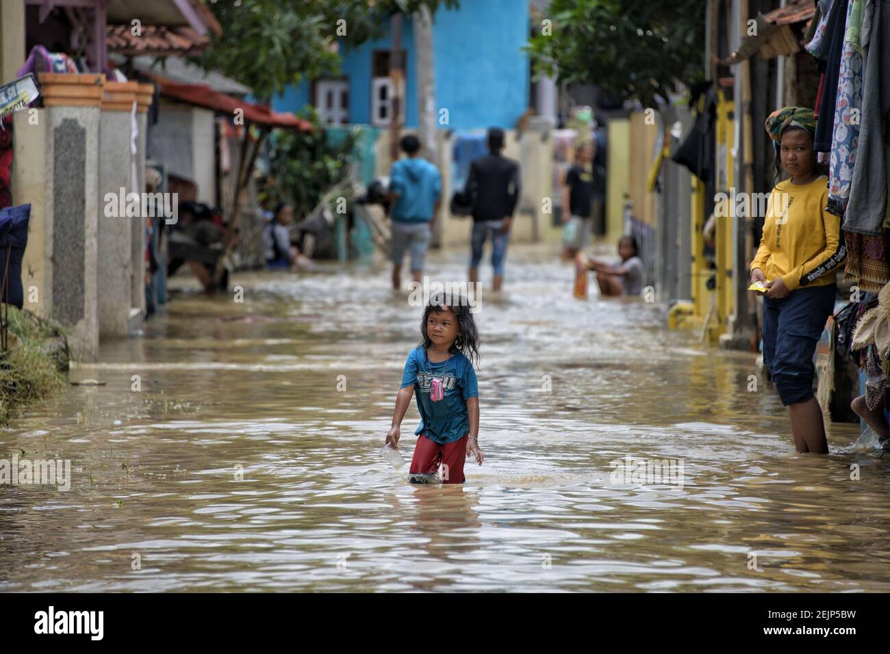 A children plays during a flood in Pamanukan, Subang Regency, West Java ...