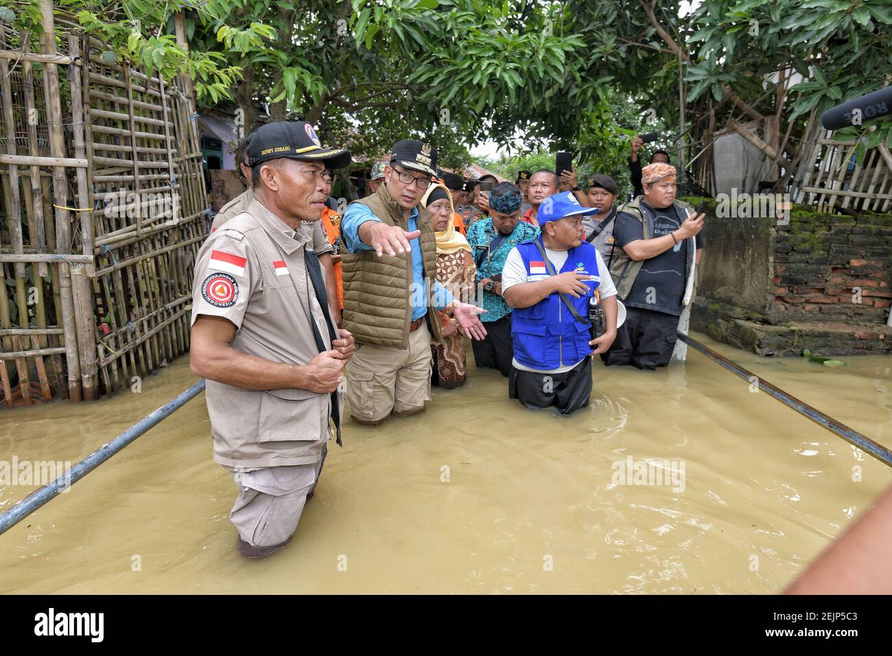 Governor of West Java, Ridwan Kamil (two from left), visited the flood ...