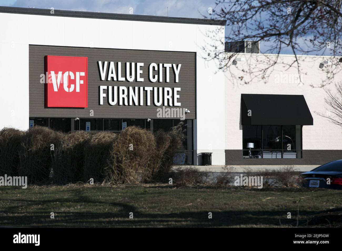 A logo sign outside of a Value City Furniture (VCF) retail store