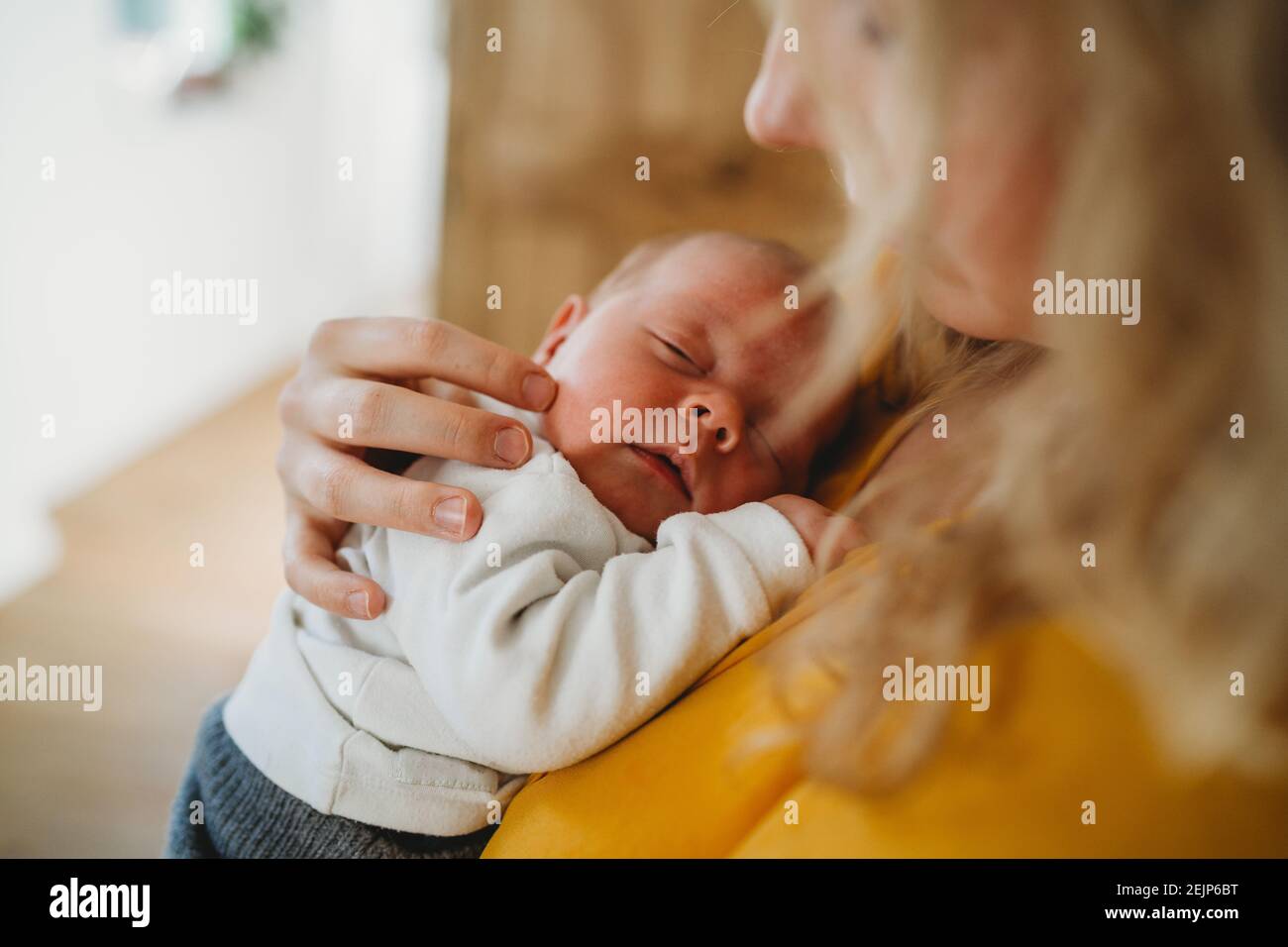 Close up of white newborn baby sleeping in mom's arms Stock Photo Alamy