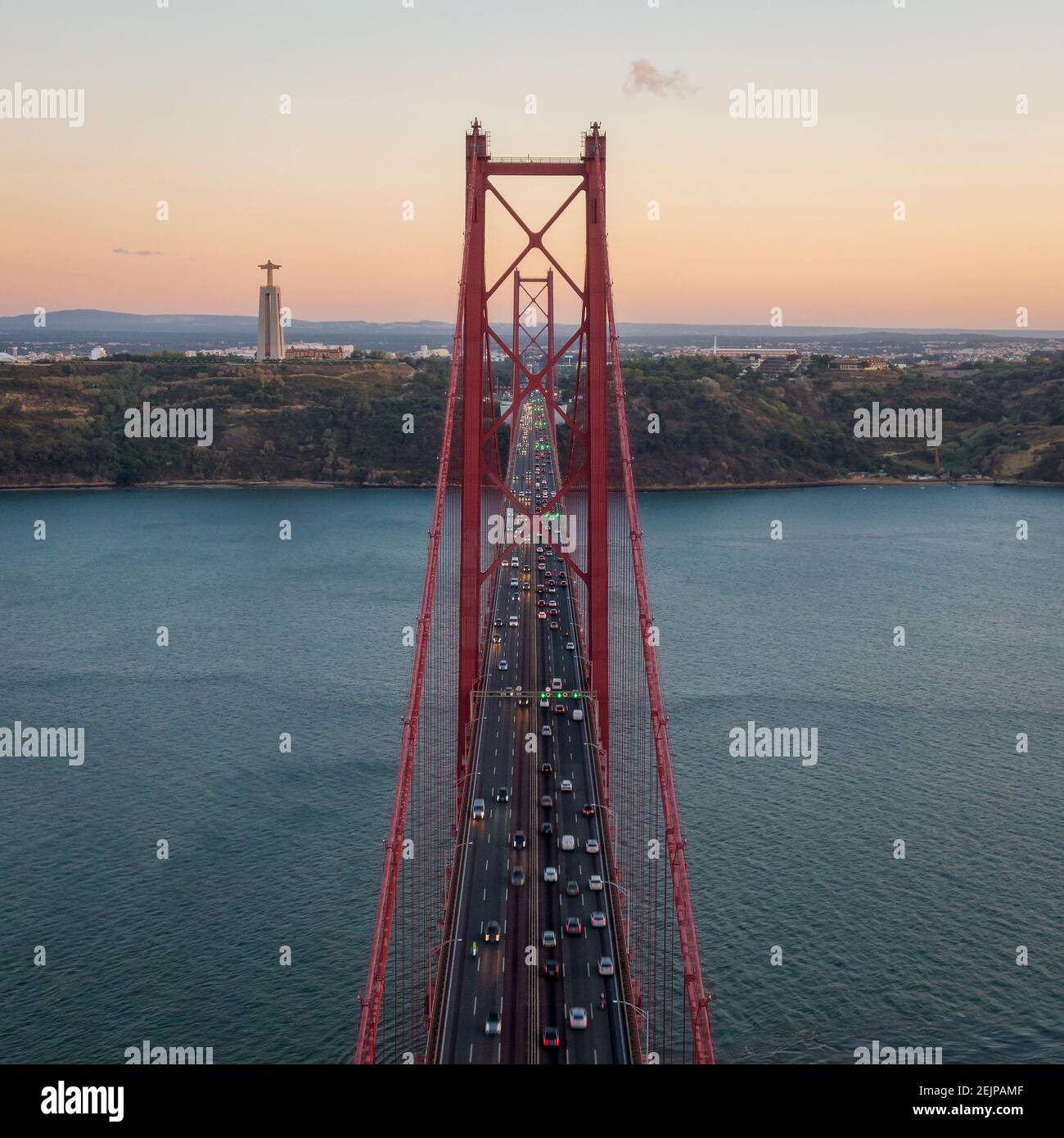 Aerial view of traffic on the 25 de Abril Bridge over the Tagus River at sunset in Lisbon, Portugal. Stock Photo