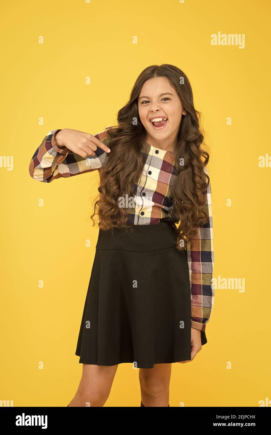 Essential back to school uniform garment. Happy child pointing finger