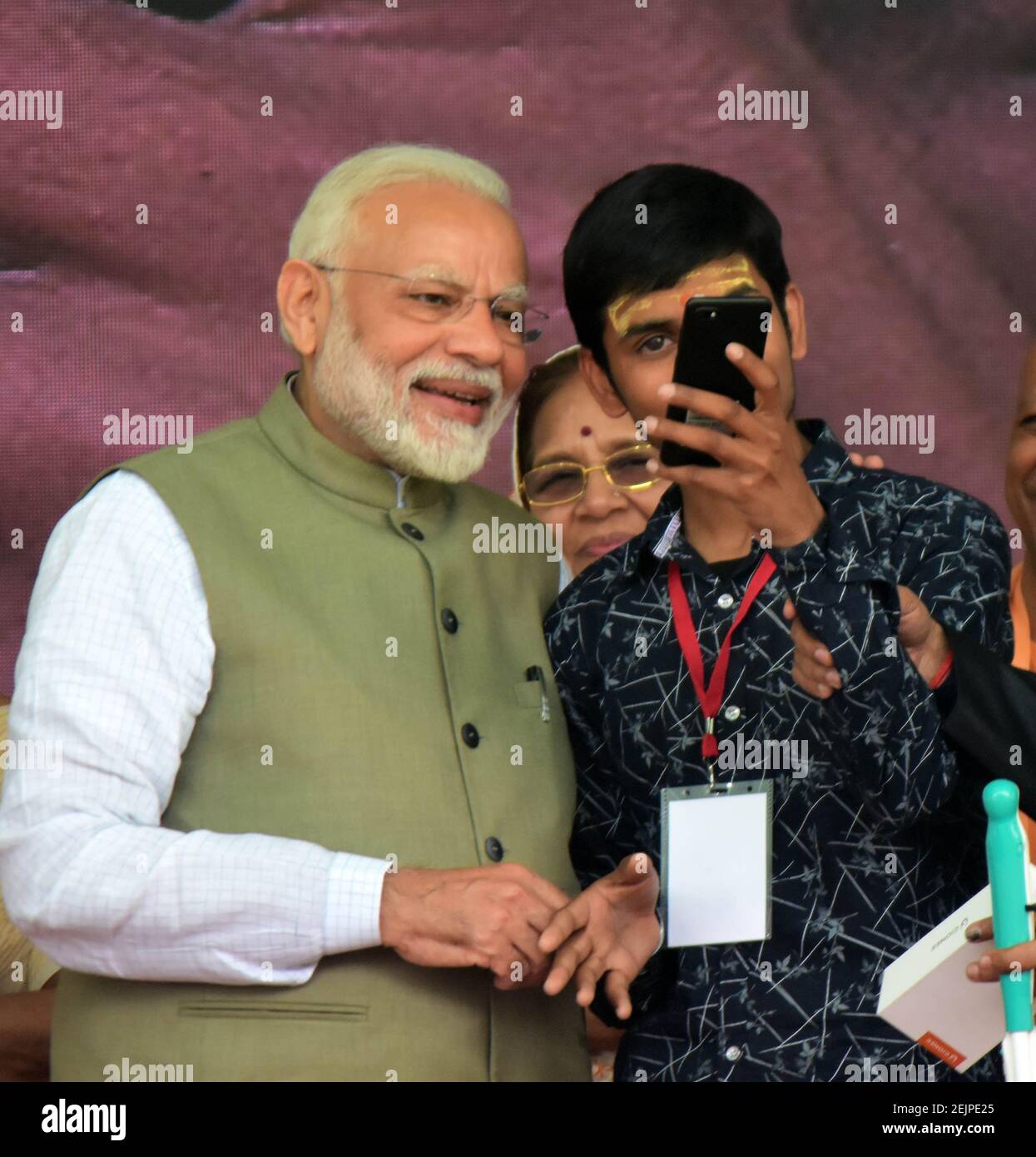 A beneficiary taking selfie with Prime minister Narednra Modi during a program to distribute tricycle and other equipment to beneficiary at parade ground in Prayagraj Photo by Prabhat Kumar Verma Paci...