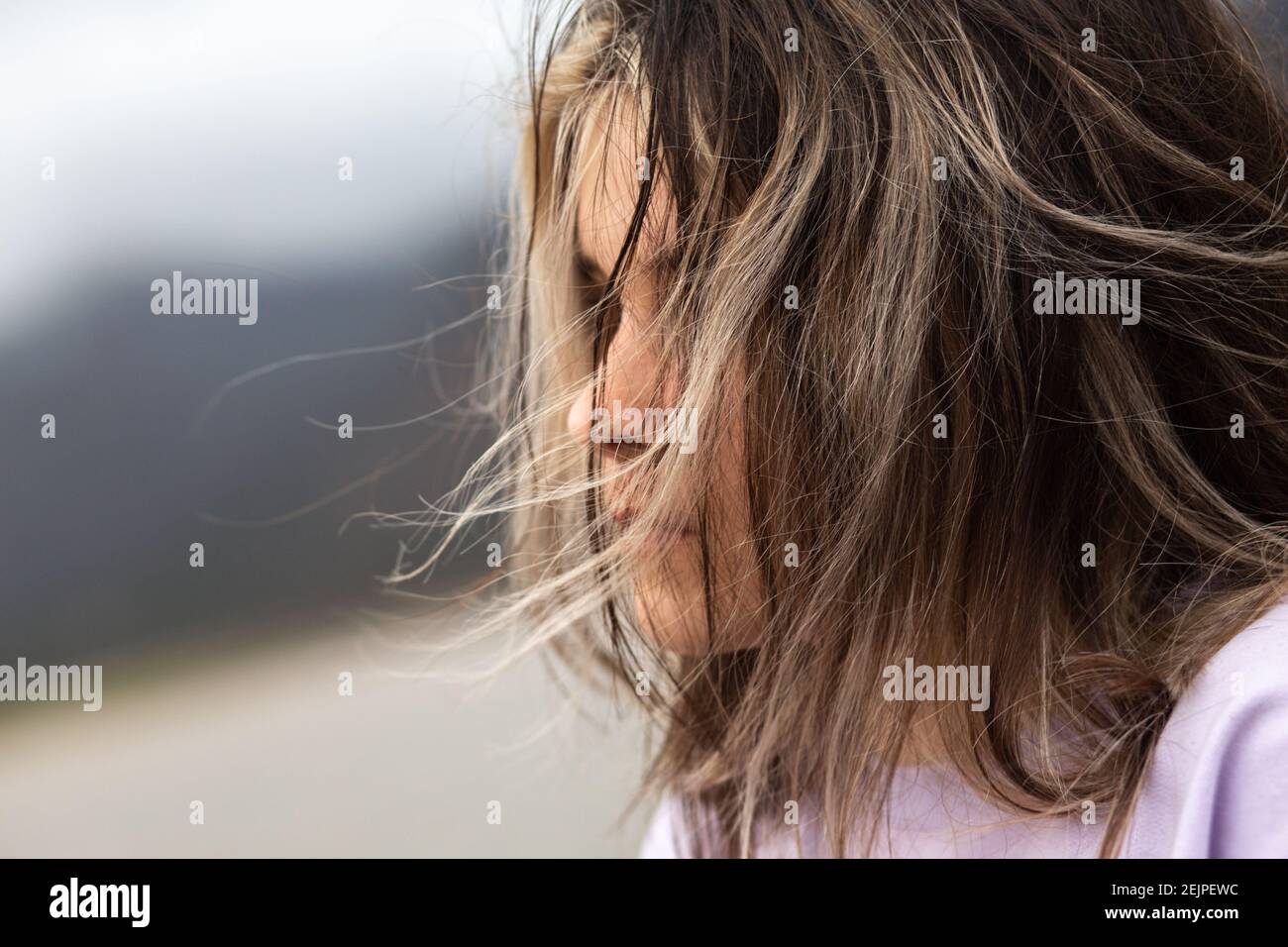 Young girl's hair blowing in the wind Stock Photo