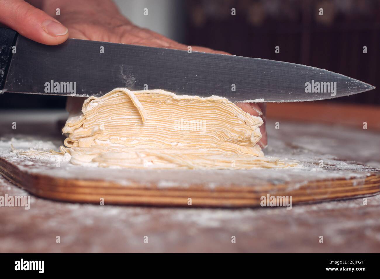 Cook making spaghetti, knife, dough, flour Stock Photo Alamy