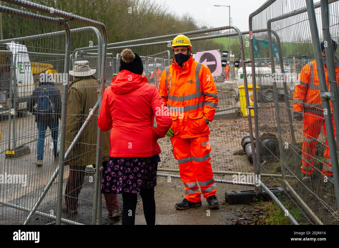 Amersham, Buckinghamshire, UK. 22nd February, 2021. HS2 Ltd are building a ventilation shaft headhouse in Amersham for the High Speed Rail link from London to Birmingham. The Whielden Lane footpath has been fenced off through the site. This morning an HS2 Security guard was following and filming a member of the press on the public footpath as well as ignoring social distancing. Credit: Maureen McLean/Alamy Stock Photo