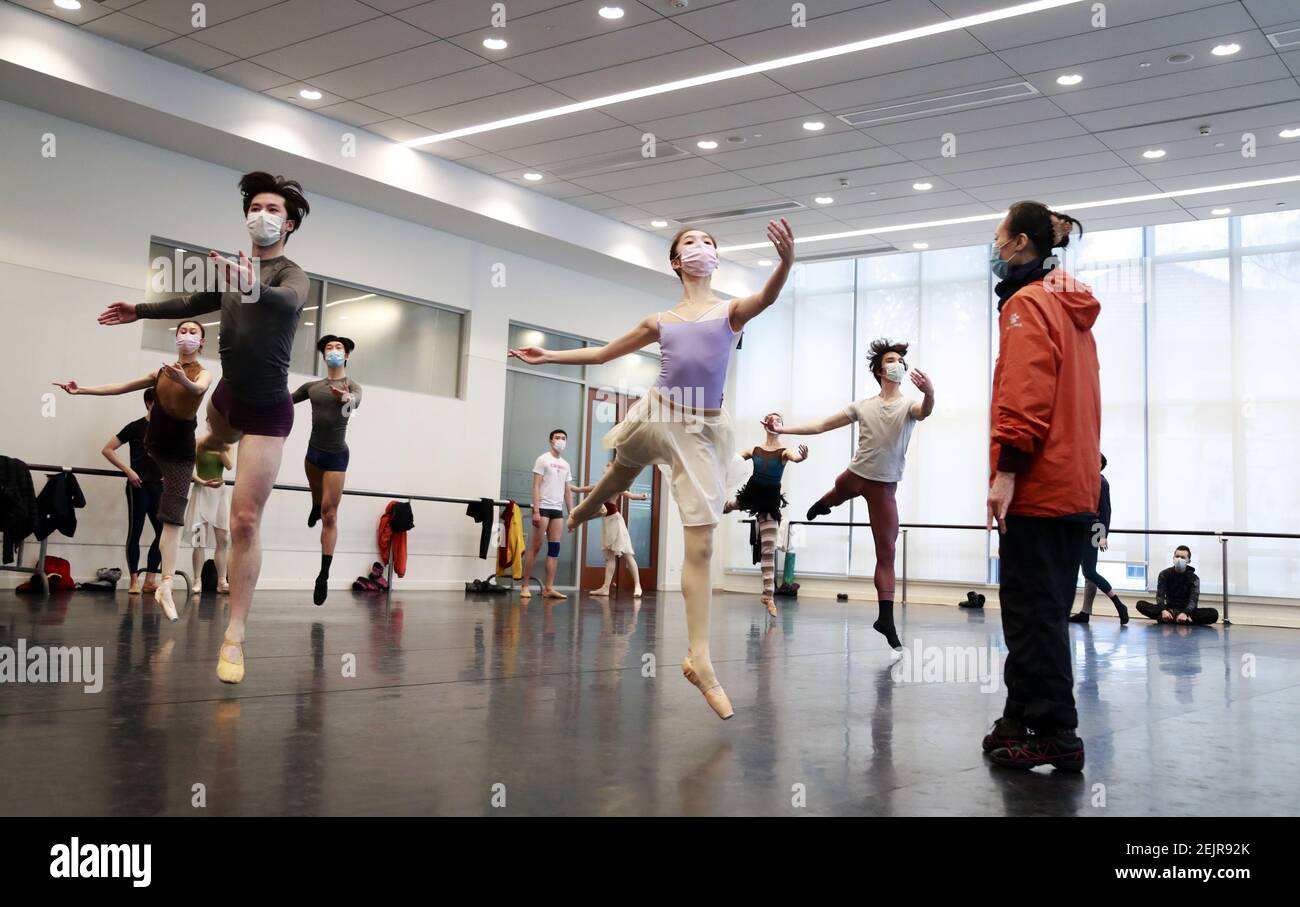 The ballet dancers are practicing in the rehearsal room by wearing ...