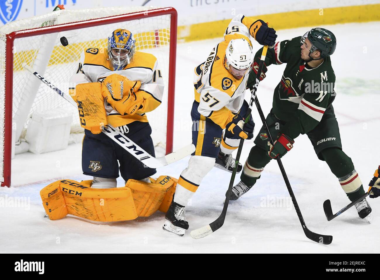 Nashville Predators goaltender Juuse Saros (74) turns away a shot as the Minnesota Wild's Zach Parise (11) vies for position with defenseman Dante Fabbro (57) in the first period on Tuesday, March 3, 2020 at the Xcel Energy Center in St. Paul, MInn. The Wild won, 3-1. (Aaron Lavinsky/Minneapolis Star Tribune/TNS) Stock Photo