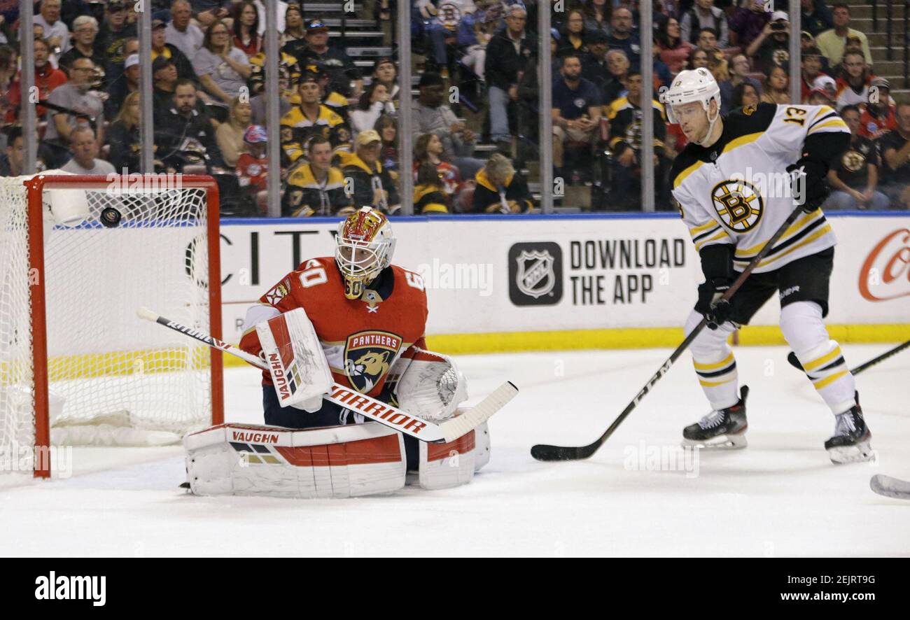 Boston Bruins' Charlie Coyle (13) grabs the jersey of Pittsburgh Penguins'  Brian Dumoulin (8) during the second period of an NHL hockey game in  Pittsburgh, Sunday, April 25, 2021. The Penguins won