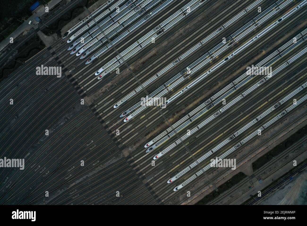 An aerial view of high-speed trains gathering at night after ...