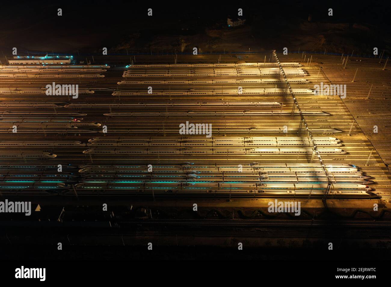 An aerial view of high-speed trains gathering at night after ...