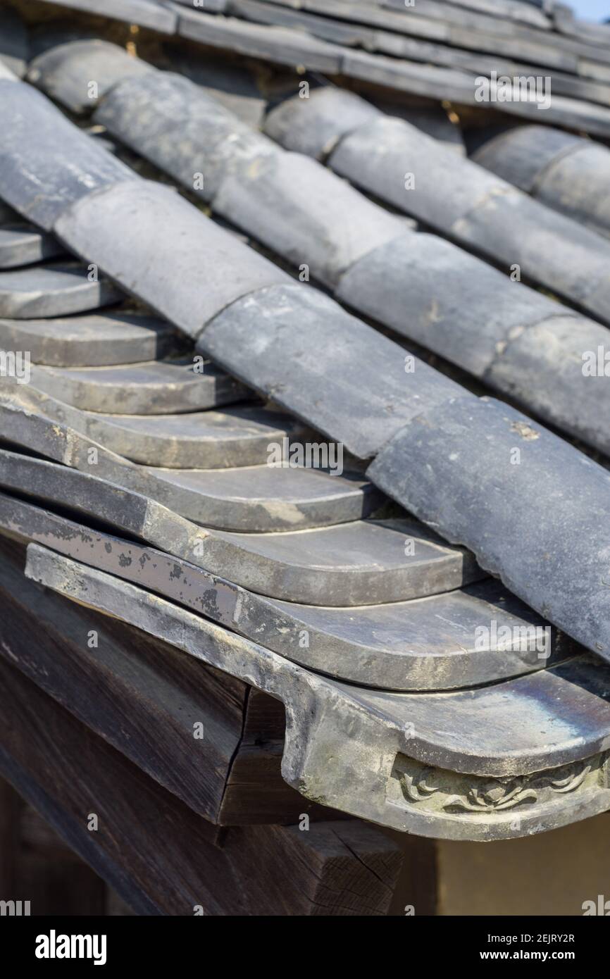 Traditional Japanese grey ceramic roofing tiles or kawara, on a roof at