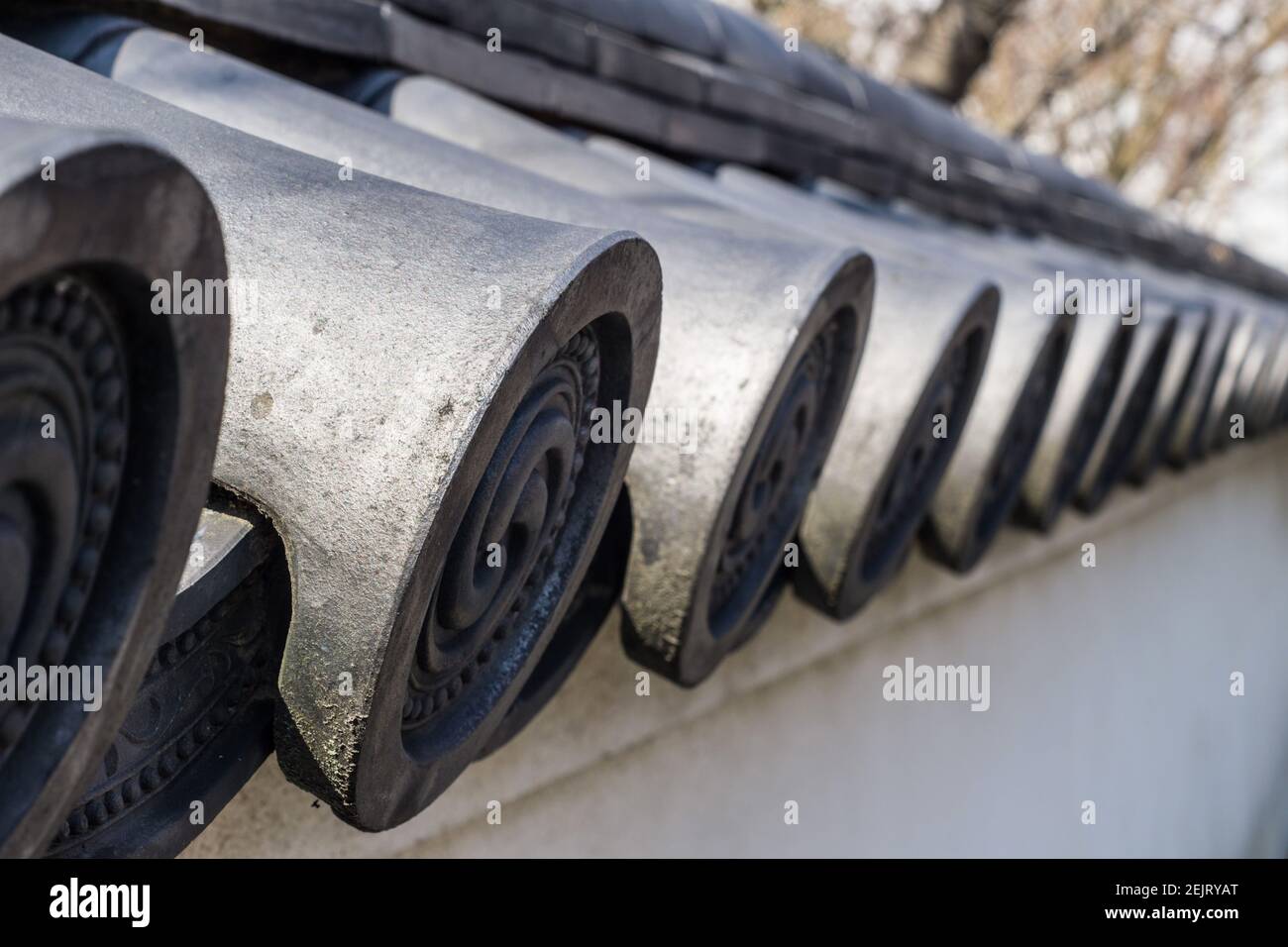 Traditional Japanese grey ceramic roofing tiles or kawara, on a roof at