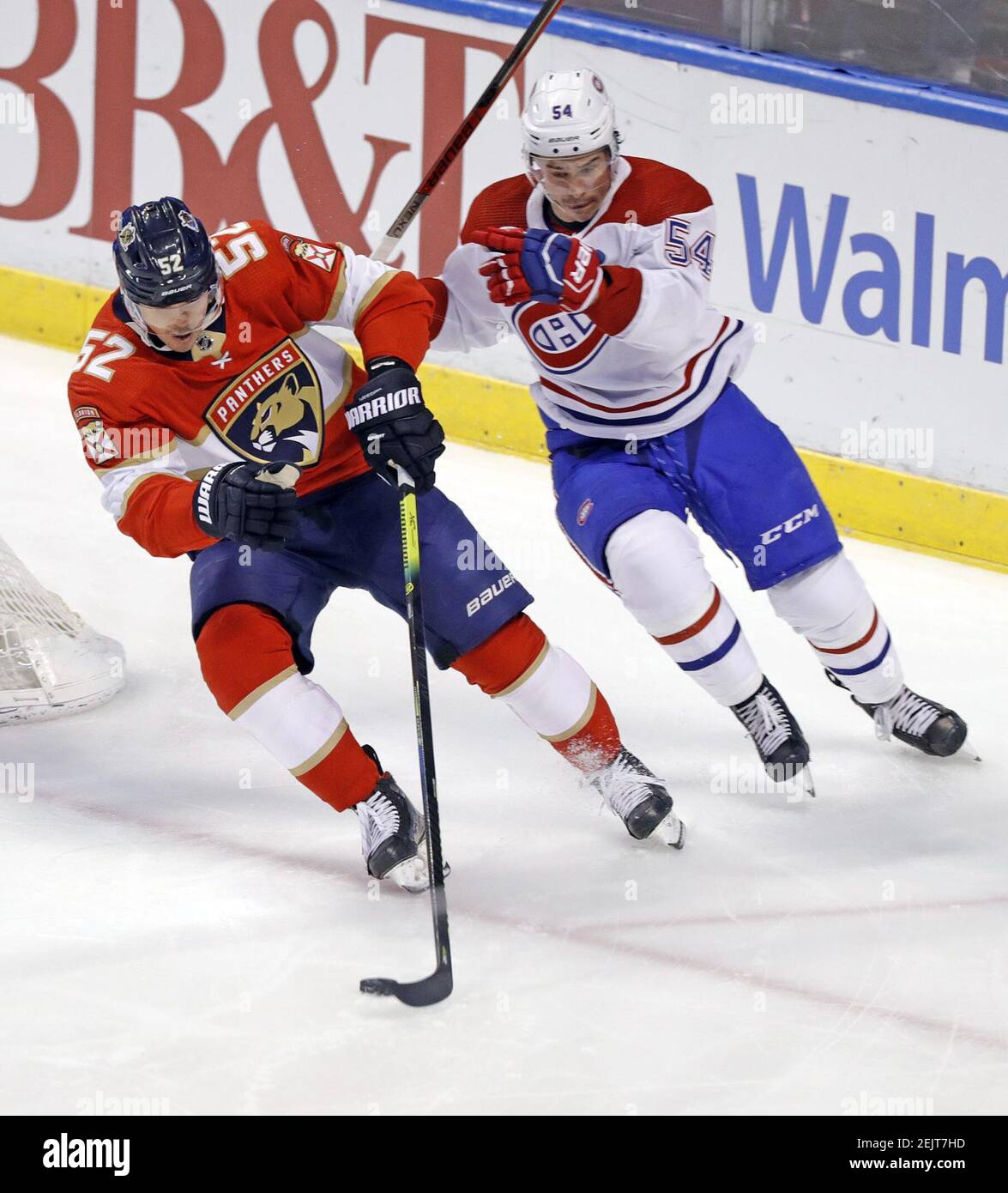 The Florida Panthers' MacKenzie Weegar (52) hits the puck as the Montreal Canadiens' Charles Hudon pursues in the first period at the BB&T Center in Sunrise, Fla., on Saturday, March 7, 2020. The Panthers won, 4-1. (Al Diaz/Miami Herald/TNS) Stock Photo