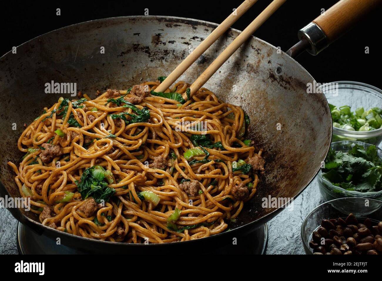 Noodles are tossed in an oil flavored with Sichuan peppercorns, then finished with peanuts, green onions, cilantro, garlic and more peppercorns but this time ground into a powder. (E. Jason Wambsgans/Chicago Tribune/TNS) Stock Photo