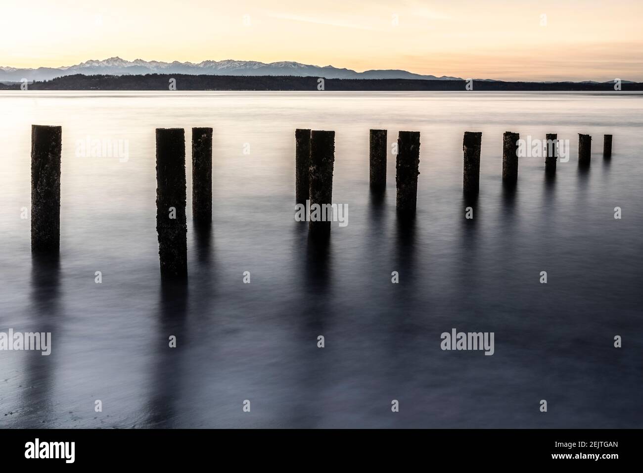 WA20074-00.....WASHINGTON - Edmonds waterfront looking across the Puget Sound to the Olympic Mountains at sunset. Stock Photo