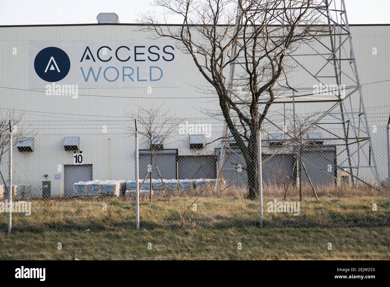 A logo sign outside of a facility occupied by Access World in Edgemere ...